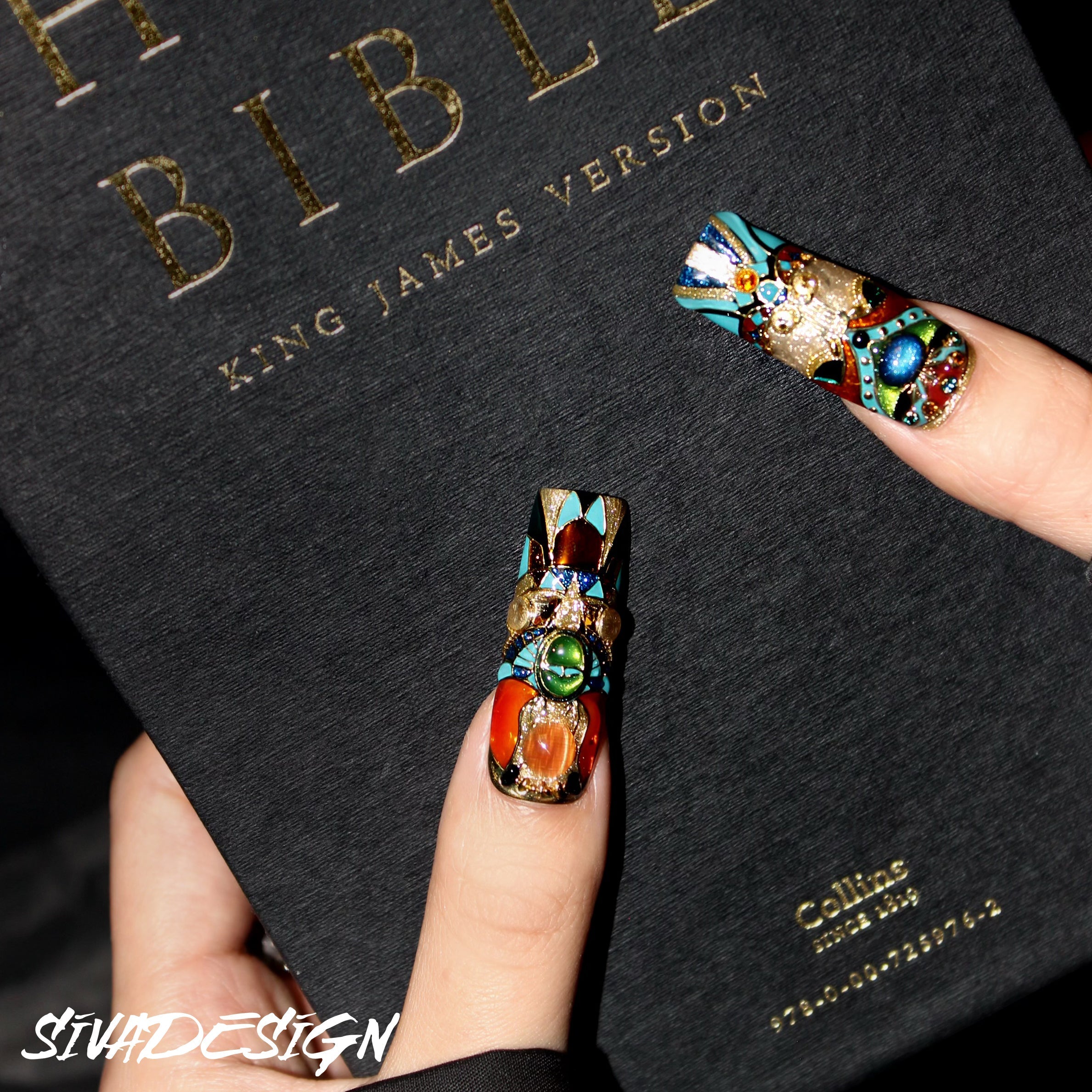 High-quality custom press-on nails with detailed designs and luxurious gemstone accents in vibrant colors